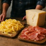 Table with Parmigiano Reggiano, prosciutto and fresh pasta